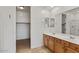 Bright bathroom with double sinks, a large mirror, and a walk-in shower at 318 S Leandro --, Mesa, AZ 85208