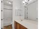 Bright bathroom features a large mirror, white counters, and wood cabinets at 318 S Leandro --, Mesa, AZ 85208