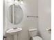 Bright half bathroom with modern fixtures, pedestal sink, and decorative mirror at 318 S Leandro --, Mesa, AZ 85208