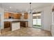 Open kitchen features an island, granite countertops, light wood cabinetry and stainless steel appliances at 318 S Leandro --, Mesa, AZ 85208