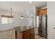 A kitchen island in this home offers extra cabinet space and blends seemlessly into the open floor plan at 318 S Leandro --, Mesa, AZ 85208