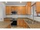 Close-up shot of the kitchen, including stainless steel appliances, granite countertops, and maple cabinets at 318 S Leandro --, Mesa, AZ 85208