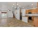 Open-concept room with living room, kitchen with island, stainless steel appliances, and staircase to the second level at 318 S Leandro --, Mesa, AZ 85208