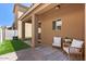 Covered patio space with brick flooring, a ceiling fan, and comfortable seating area at 318 S Leandro --, Mesa, AZ 85208