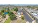 An aerial view of a community with a pool, mini golf, lake, parking lot, and houses on a sunny day at 3433 E Sandra Ter, Phoenix, AZ 85032