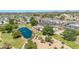 Aerial view of a lake with bridge, pool, parking lot, and houses in a community on a sunny day at 3433 E Sandra Ter, Phoenix, AZ 85032