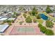 Aerial view of a tennis court and lake surrounded by trees in a community on a sunny day at 3433 E Sandra Ter, Phoenix, AZ 85032