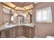Dual sinks, marble countertop, and elegant lighting fixtures in this bathroom at 3433 E Sandra Ter, Phoenix, AZ 85032