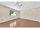 Well-lit bedroom features hardwood floors and a window with a view at 3433 E Sandra Ter, Phoenix, AZ 85032