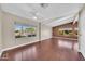 Bright bedroom showcasing hardwood floors, a ceiling fan, and large windows offering natural light at 3433 E Sandra Ter, Phoenix, AZ 85032