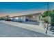Exterior of the house featuring a carport, desert landscaping, and mature trees at 3433 E Sandra Ter, Phoenix, AZ 85032