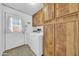 Functional laundry area with wooden cabinetry, washer, dryer, and an exterior door at 3433 E Sandra Ter, Phoenix, AZ 85032
