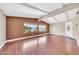 Open-concept living area with hardwood floors, large windows, and white front door at 3433 E Sandra Ter, Phoenix, AZ 85032