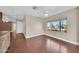 Open living space with hardwood floors, ceiling fans, and large window at 3433 E Sandra Ter, Phoenix, AZ 85032