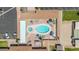 Aerial view of a pool with umbrellas, lounge chairs, tables, palm trees, and parking lot at 3433 E Sandra Ter, Phoenix, AZ 85032