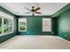 Spacious carpeted bedroom featuring a ceiling fan and bright windows offering neighborhood views at 3623 E Horace Dr, Gilbert, AZ 85296