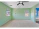 Spacious bedroom with light green walls, carpet flooring and two windows at 3623 E Horace Dr, Gilbert, AZ 85296
