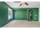Cozy carpeted bedroom featuring a ceiling fan, and a sunny window overlooking the yard at 3623 E Horace Dr, Gilbert, AZ 85296