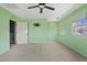 Spacious bedroom with light green walls, carpet, and a window overlooking the street at 3623 E Horace Dr, Gilbert, AZ 85296