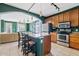 The kitchen features an island with seating, stainless steel appliances, and a breakfast bar at 3623 E Horace Dr, Gilbert, AZ 85296