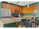 The kitchen features an island with seating, stainless steel appliances, and granite countertops at 3623 E Horace Dr, Gilbert, AZ 85296