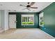 Bright living room with white carpet, ceiling fan and sunlit windows overlooking the landscaped front yard at 3623 E Horace Dr, Gilbert, AZ 85296