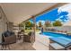 Inviting backyard with covered patio, comfortable seating, and a sparkling pool for outdoor relaxation at 3701 E Morrow Dr, Phoenix, AZ 85050