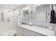 Stylish bathroom featuring double sinks, marble countertops, and a glass-enclosed shower at 3701 E Morrow Dr, Phoenix, AZ 85050