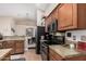 Modern kitchen equipped with stainless steel appliances, wooden cabinets, and granite countertops at 3701 E Morrow Dr, Phoenix, AZ 85050