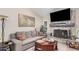 Cozy living room featuring a stone fireplace, a comfortable sofa, and stylish decor at 3701 E Morrow Dr, Phoenix, AZ 85050
