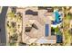 Stunning aerial view of a home with a tile roof, pool, basketball court, and solar panels at 37301 N 99Th St, Scottsdale, AZ 85262