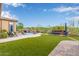 A luxurious backyard features a sparkling pool and an outdoor fireplace at 37301 N 99Th St, Scottsdale, AZ 85262
