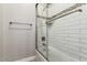 Bathroom featuring a glass shower with bright subway tile and mosaic tile accent at 37301 N 99Th St, Scottsdale, AZ 85262