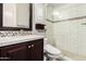Bathroom featuring a glass shower with bright subway tile and dark wood vanity at 37301 N 99Th St, Scottsdale, AZ 85262