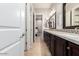 Bathroom featuring double sink vanity with dark wood cabinets with tile floors at 37301 N 99Th St, Scottsdale, AZ 85262