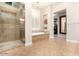 Spa-like bathroom with a glass shower, soaking tub, and a walk-in closet at 37301 N 99Th St, Scottsdale, AZ 85262