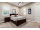 Bedroom with King bed featuring a neutral wall color, carpet flooring and modern art at 37301 N 99Th St, Scottsdale, AZ 85262