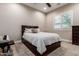 Bedroom with window and Queen bed featuring a neutral wall color and carpet flooring at 37301 N 99Th St, Scottsdale, AZ 85262