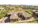 Aerial view of a desert home showing a stone and stucco exterior with tile roof and desert landscaping at 37301 N 99Th St, Scottsdale, AZ 85262