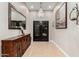 Elegant foyer with a chandelier, decorative mirror, and tiled floors at 37301 N 99Th St, Scottsdale, AZ 85262