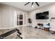 Home gym featuring exercise equipment, a TV, and French doors leading to a butler's pantry at 37301 N 99Th St, Scottsdale, AZ 85262
