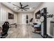 Spacious home gym with wood floors, mirrored wall, and ceiling fan; great for working out at 37301 N 99Th St, Scottsdale, AZ 85262