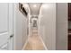 Hallway with neutral color paint and decorative art piece featuring tile floors in a modern home at 37301 N 99Th St, Scottsdale, AZ 85262