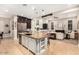 Spacious kitchen with granite countertops, stainless steel appliances, and seamless flow into the living area at 37301 N 99Th St, Scottsdale, AZ 85262
