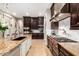 Gourmet kitchen boasts granite countertops, stainless steel appliances and rich, dark cabinetry at 37301 N 99Th St, Scottsdale, AZ 85262