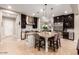 Spacious kitchen with a large center island and seating, stainless steel appliances, and pendant lighting at 37301 N 99Th St, Scottsdale, AZ 85262