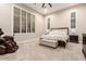 Cozy bedroom with plush carpet, a large bed, and plantation shutters for privacy and light control at 37301 N 99Th St, Scottsdale, AZ 85262