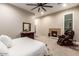 Comfortable bedroom featuring a fireplace, large bed, and cozy chair, perfect for relaxation at 37301 N 99Th St, Scottsdale, AZ 85262