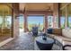 Covered patio with a comfortable seating area and views of the surrounding landscape and pool at 37301 N 99Th St, Scottsdale, AZ 85262
