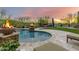 Inviting backyard pool and spa area with fire bowls, lounge chairs, and a sports court beyond at 37301 N 99Th St, Scottsdale, AZ 85262